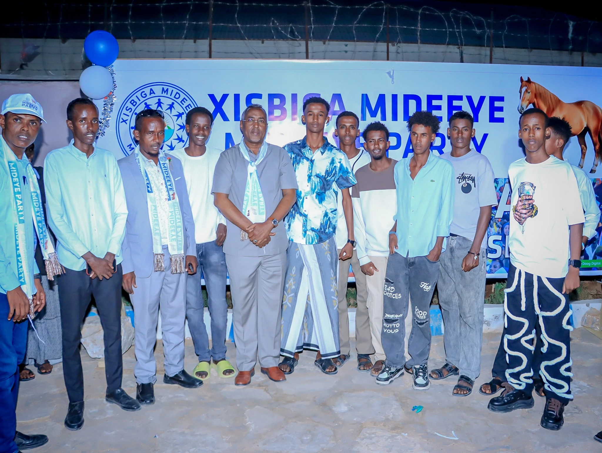 Mideeye members and youth standing together at a party event