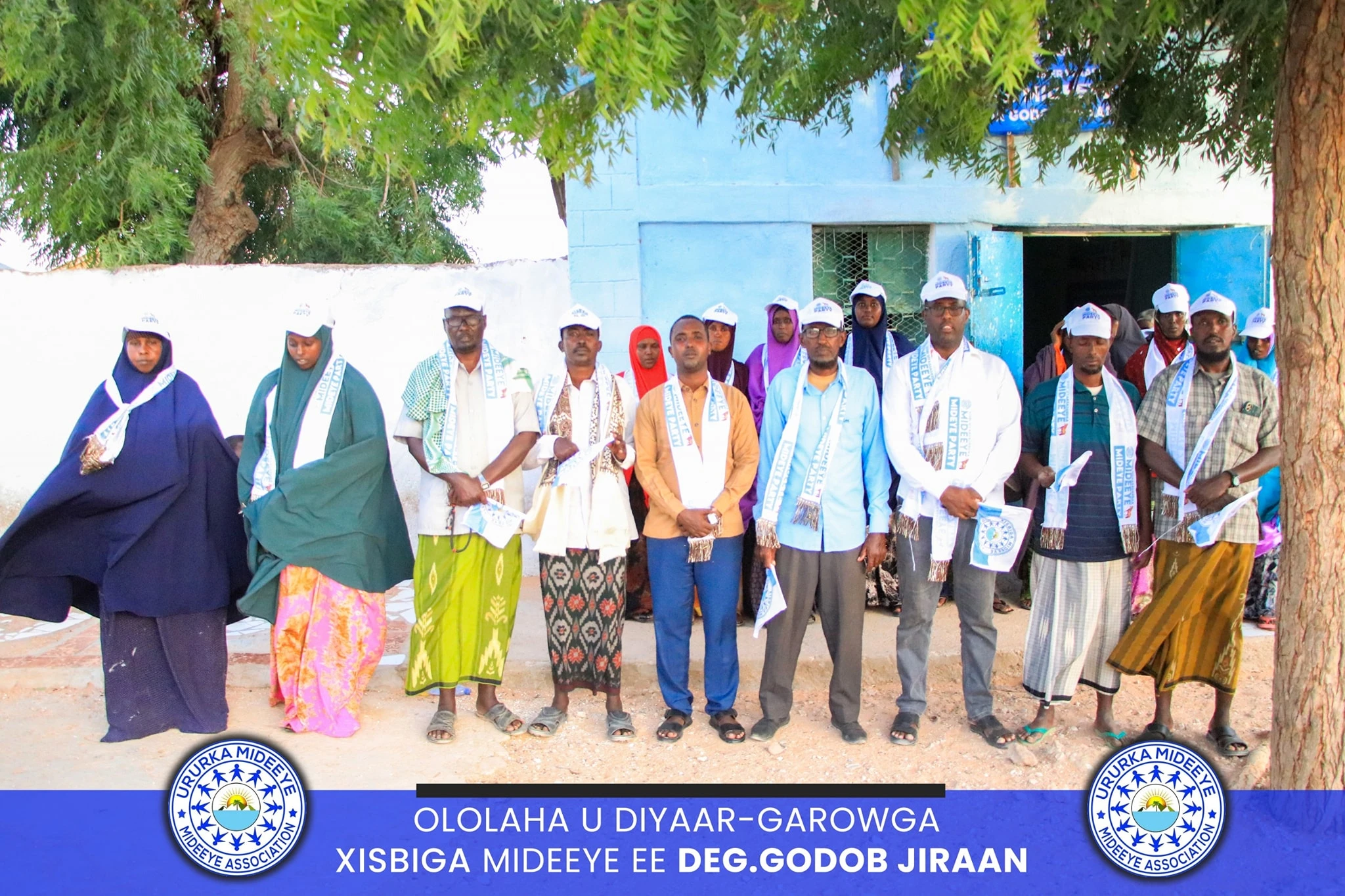 Mideeye supporters moving through a Puntland neighborhood with local storefronts visible