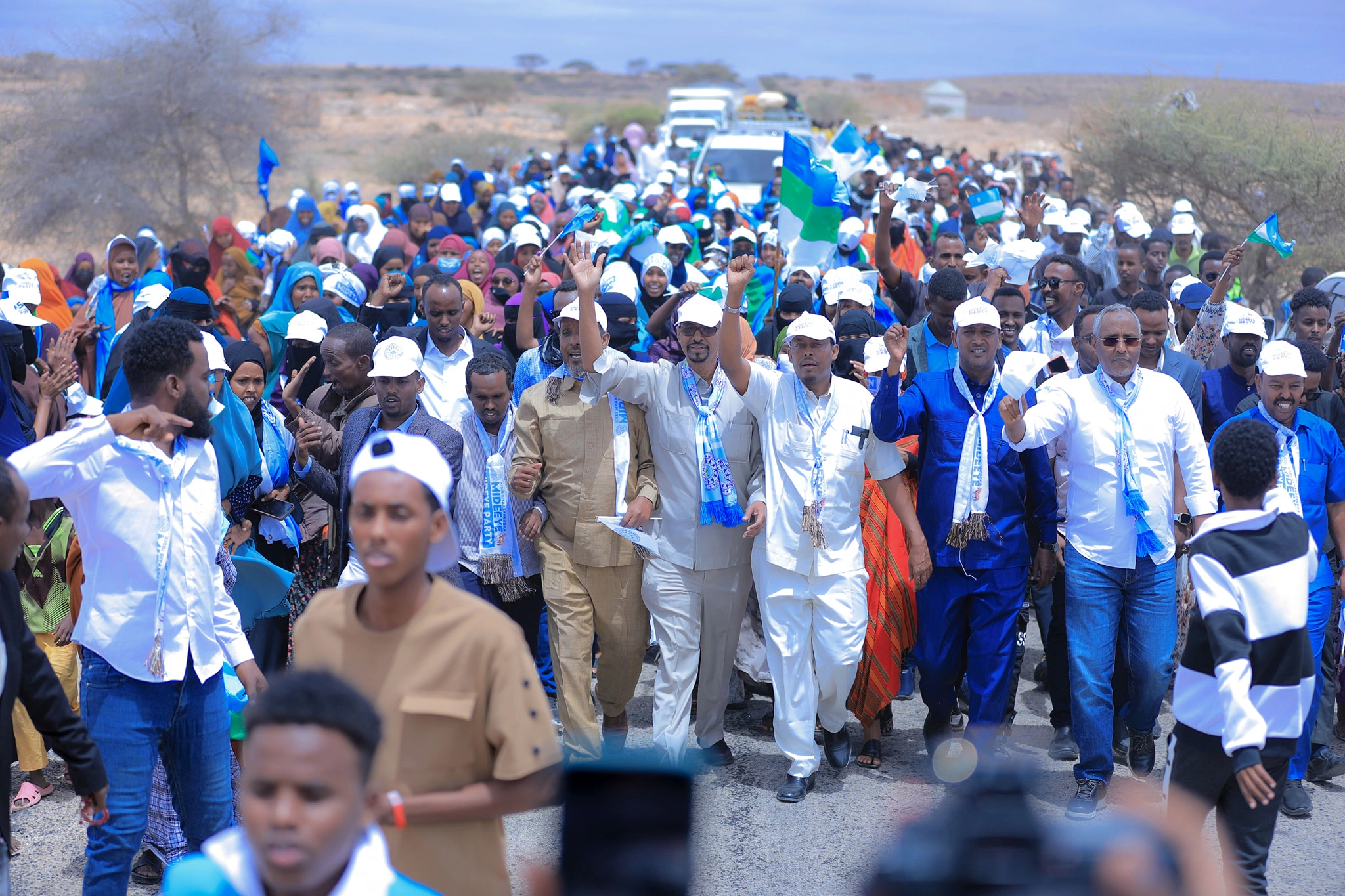 Mideeye supporters marching together with flags and party colors