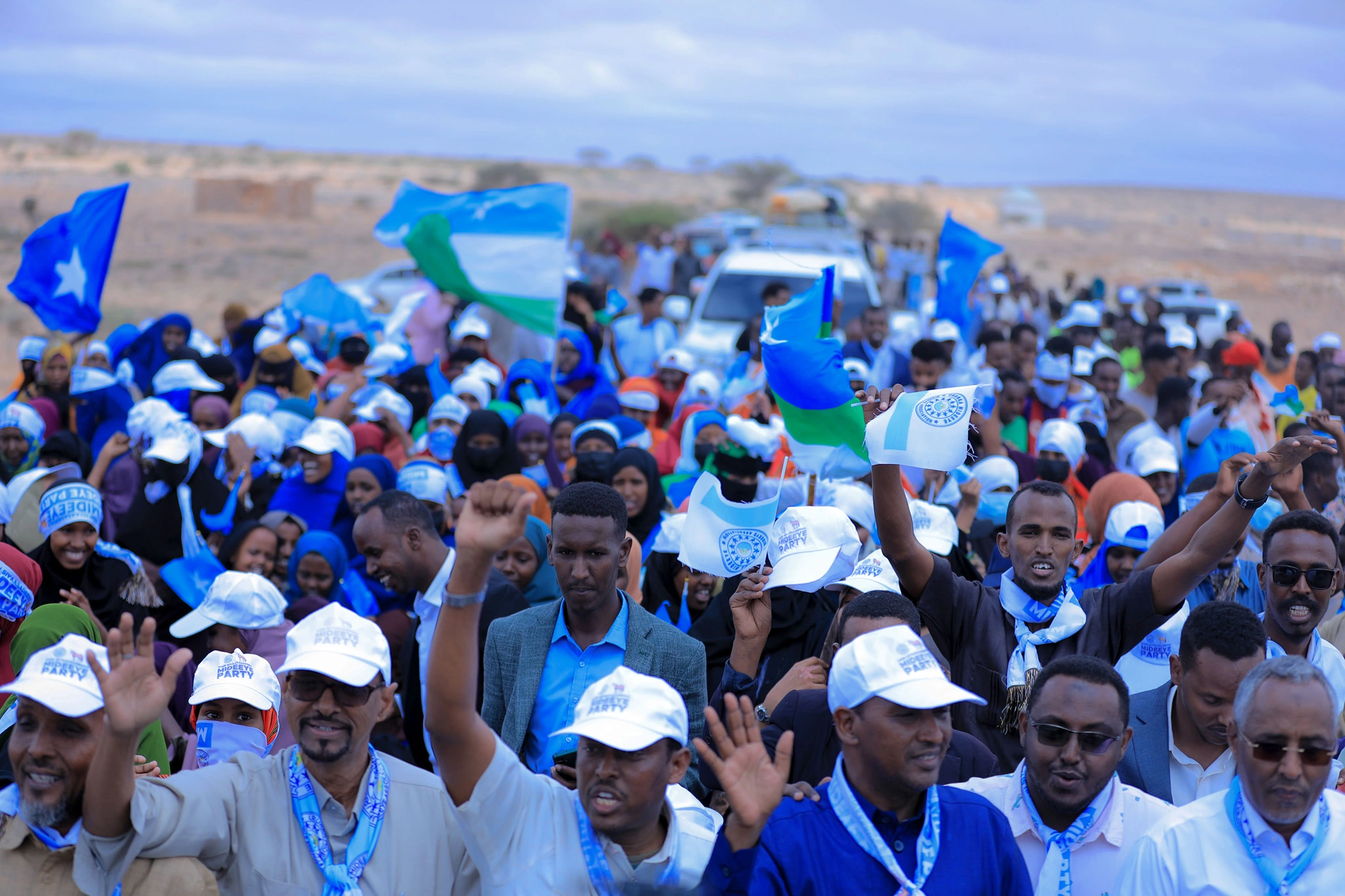 Mideeye supporters gathered on a public road with flags and party colors