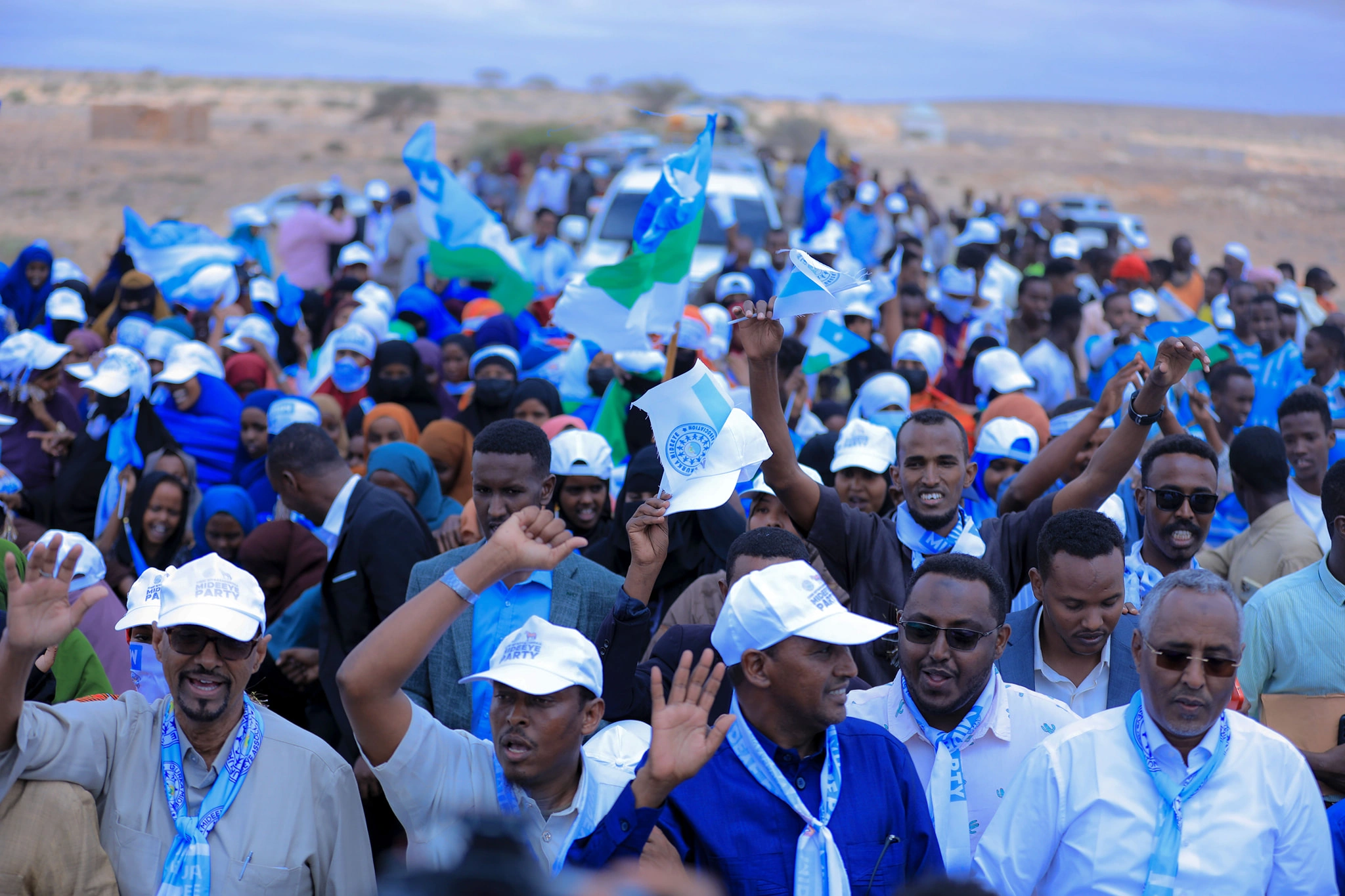 Mideeye supporters gathered with flags at a public civic event