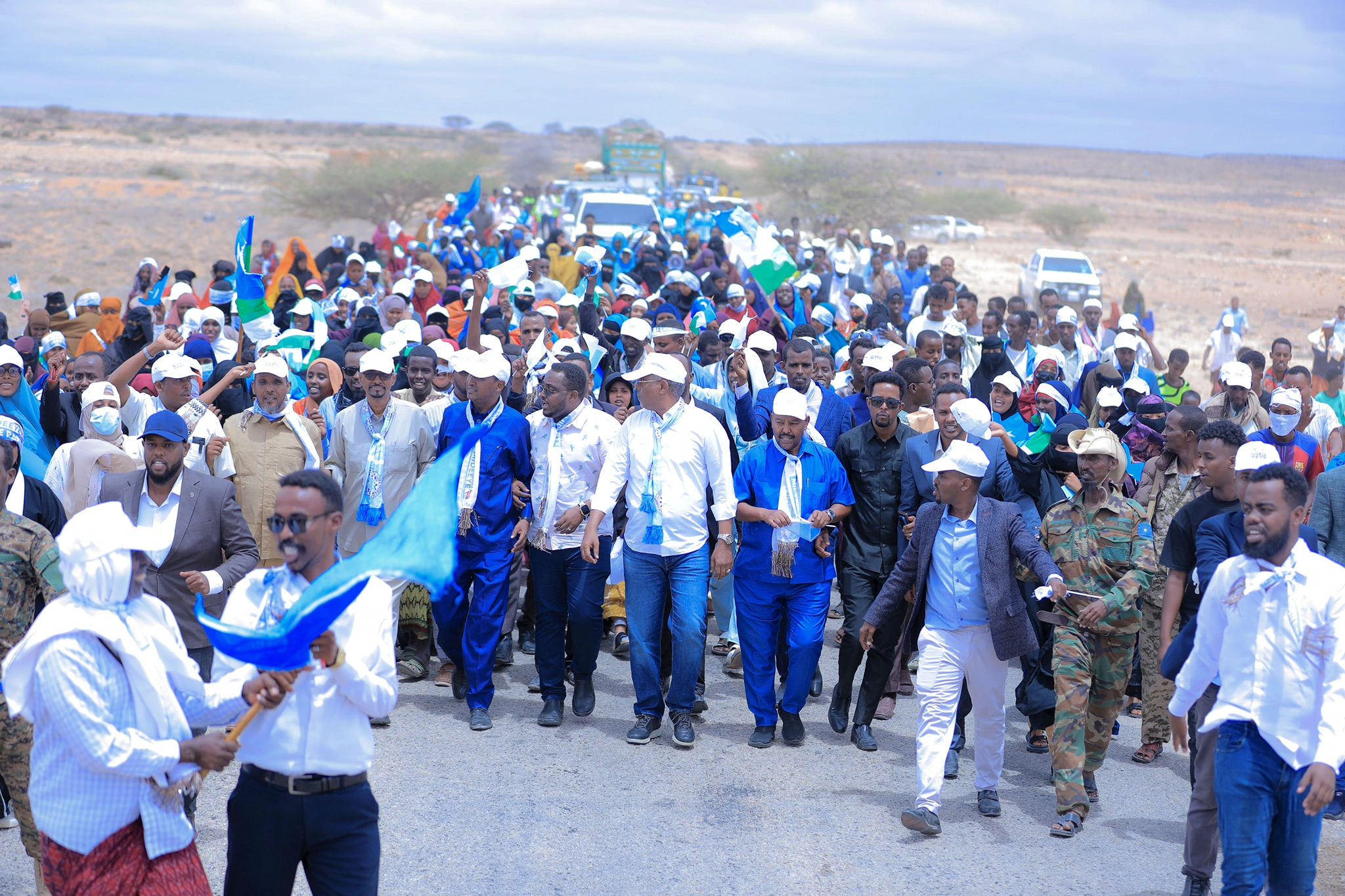 Mideeye supporters walking together with flags and party colors