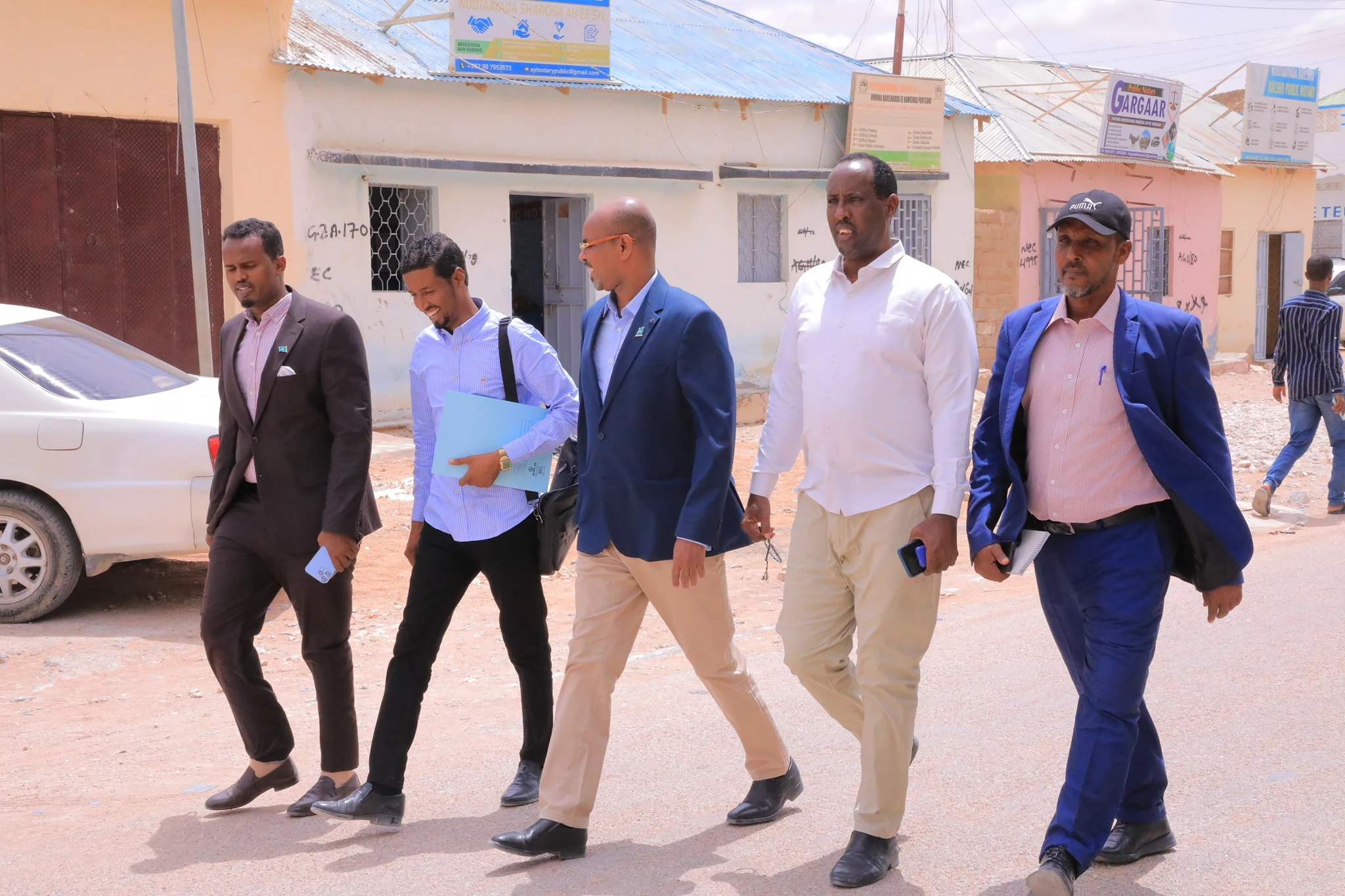 Mideeye public-service team walking through a Puntland street